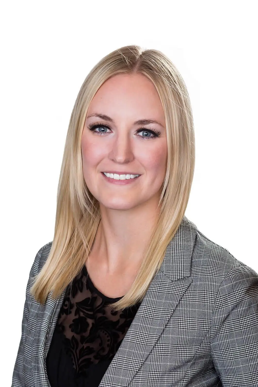 Image of Courtney Alcock, Certified Financial Planner, smiling confidently in a blazer on a white background.