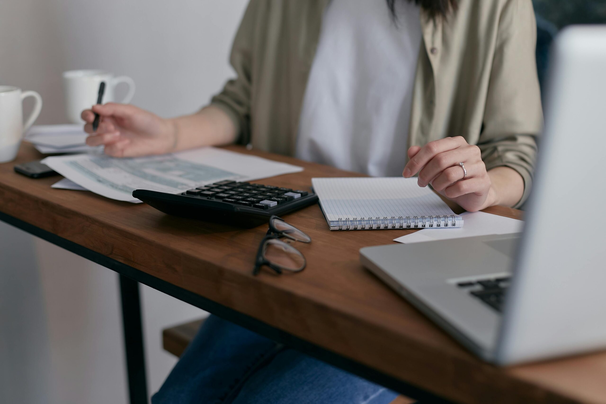 woman sitting at computer counting money