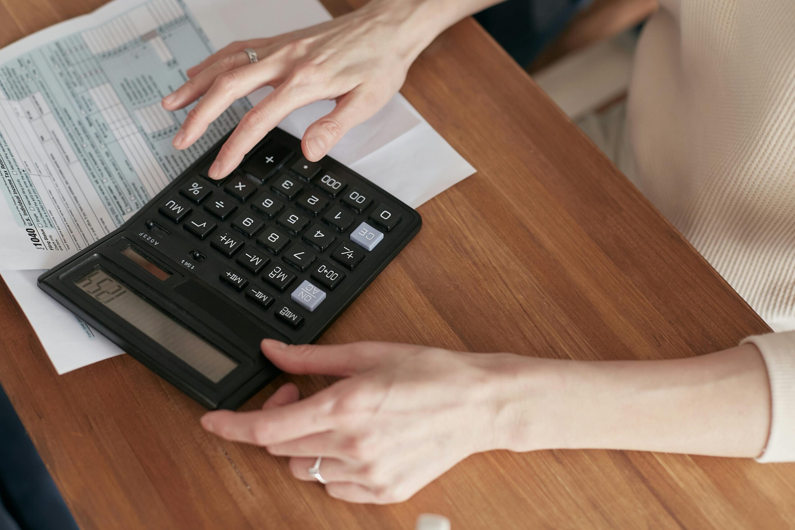 woman using calculator for taxes
